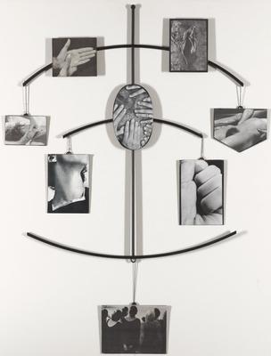 eight, black and white images affixed to black metal plates, hanging from and attached to thin, black rods; frame structure consists of one vertical rod with three, slightly curved horizontal rods intersecting at mid points; upper rod has two fixed images (hands; landscape) and two hanging images (hands around neck; nude body); middle rod has one fixed image (hands on hairy body) and two hanging images (neck; fist); bottom rod has one hanging image (crowd of people, seen from behind)